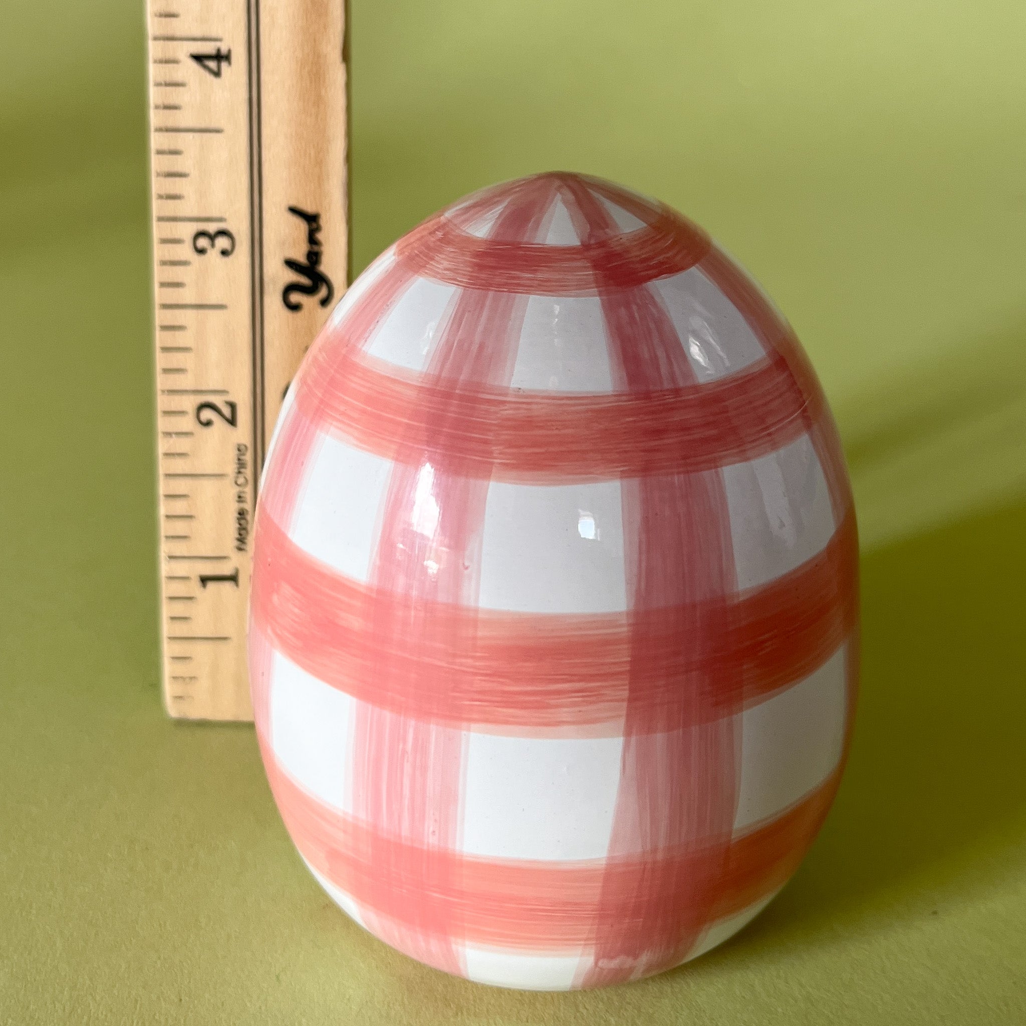 pink gingham easter egg decoration with ruler to illustrate scale
