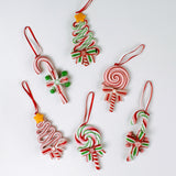 Set of six colorful candy-themed Christmas ornaments shaped like candy canes, lollipops, and Christmas trees