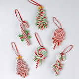 Set of six colorful candy-themed Christmas ornaments shaped like candy canes, lollipops, and Christmas trees