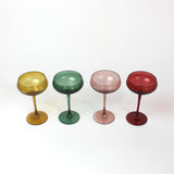 Four colorful cocktail glasses on a white background