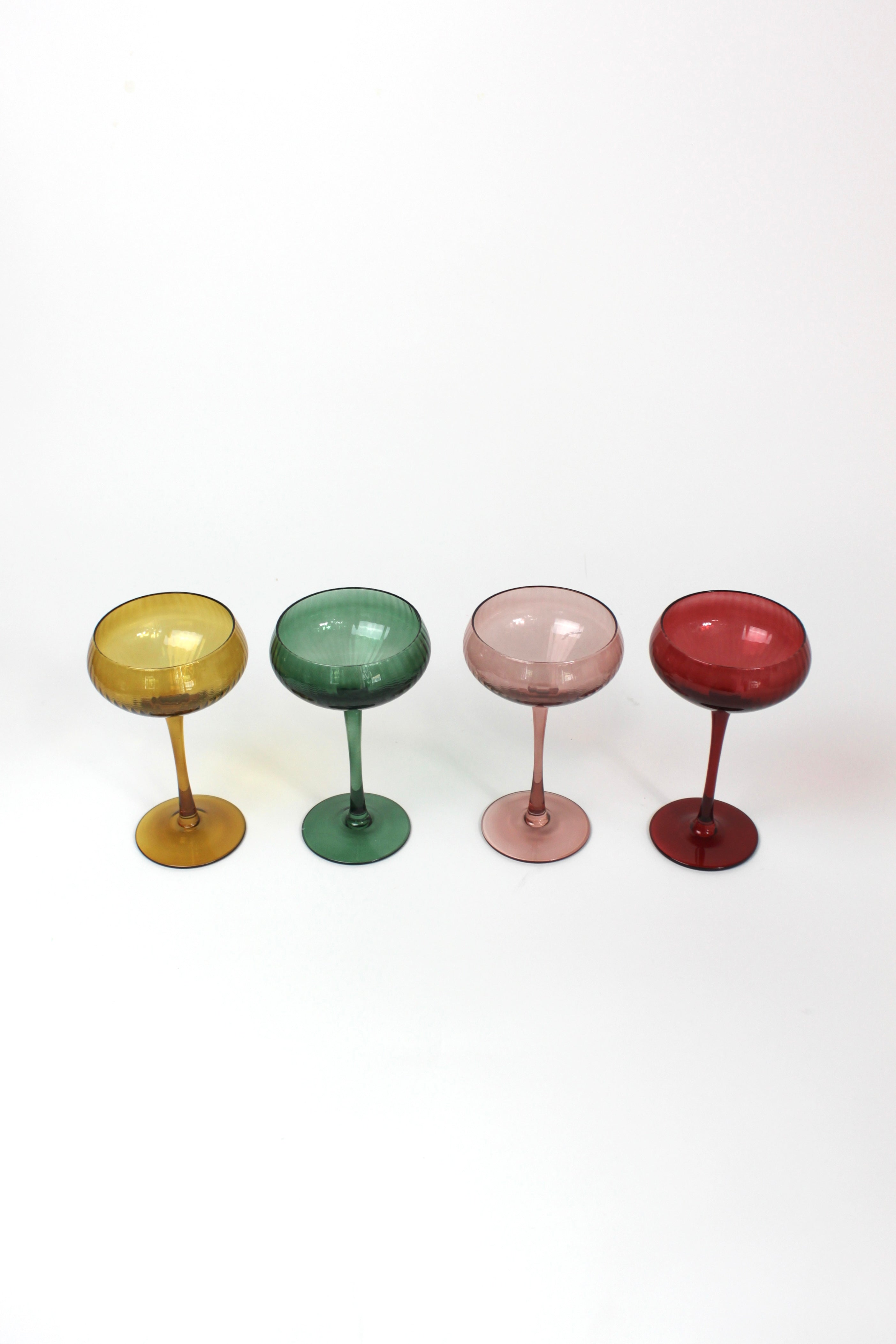 Four colorful cocktail glasses on a white background