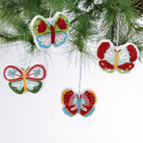 A set of four beaded butterfly felt Christmas ornaments