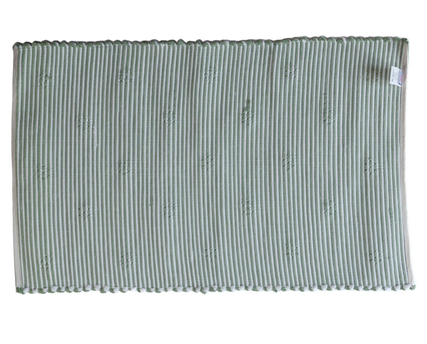 the reverse side of A rectangular green accent rug with small daisy shaped accents scattered across it.
