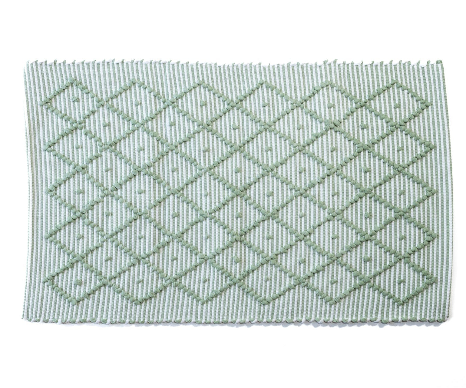 A Madcap Cottage green accent rug with a diamond pattern on the front