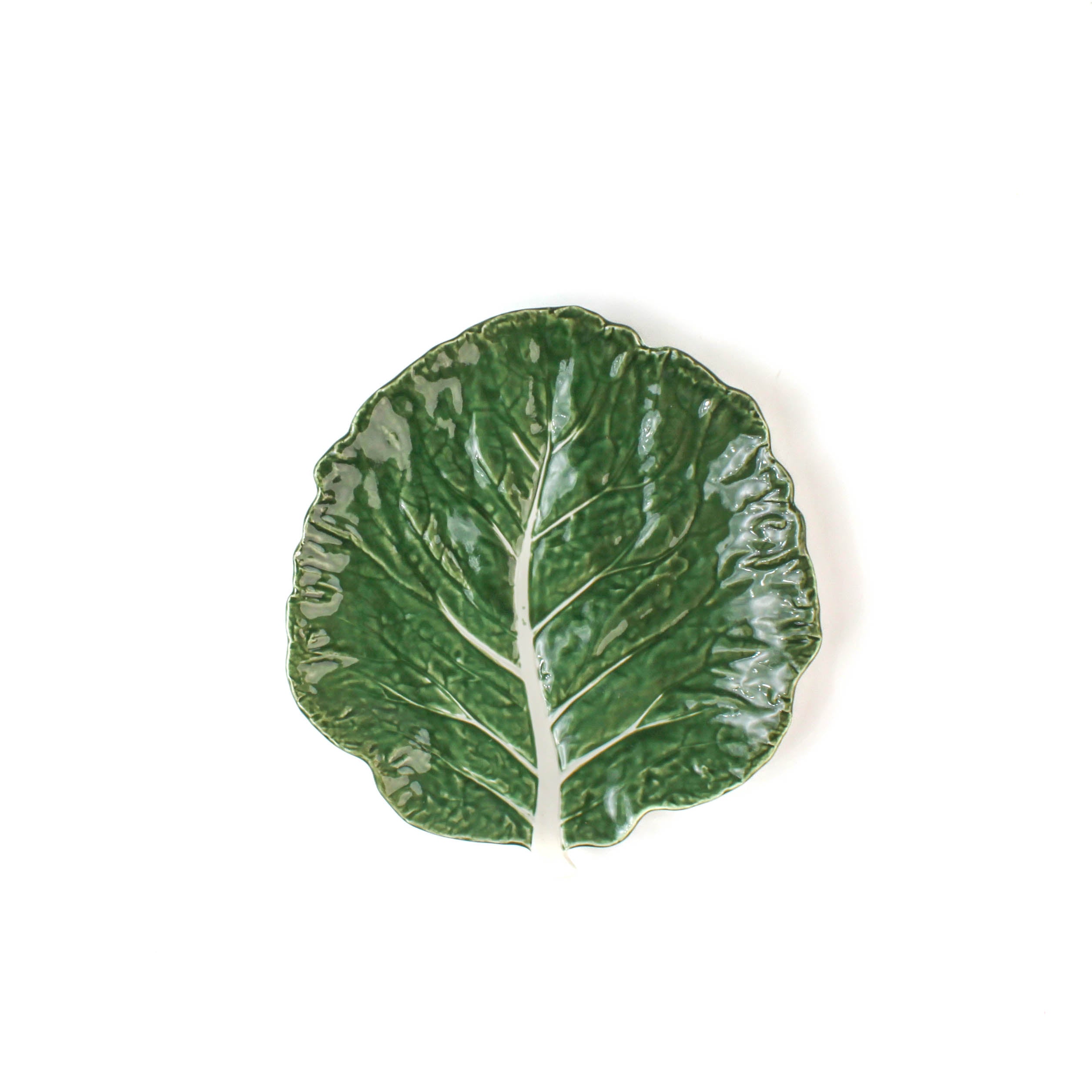 a ceramic green cabbage leaf plate on a white background.