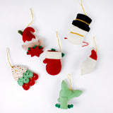 back of Handcrafted Holiday Icons Felt Christmas Ornaments featuring Santa, elf, snowman, mitten, Christmas tree, and reindeer designs in festive red, green, and white colors.