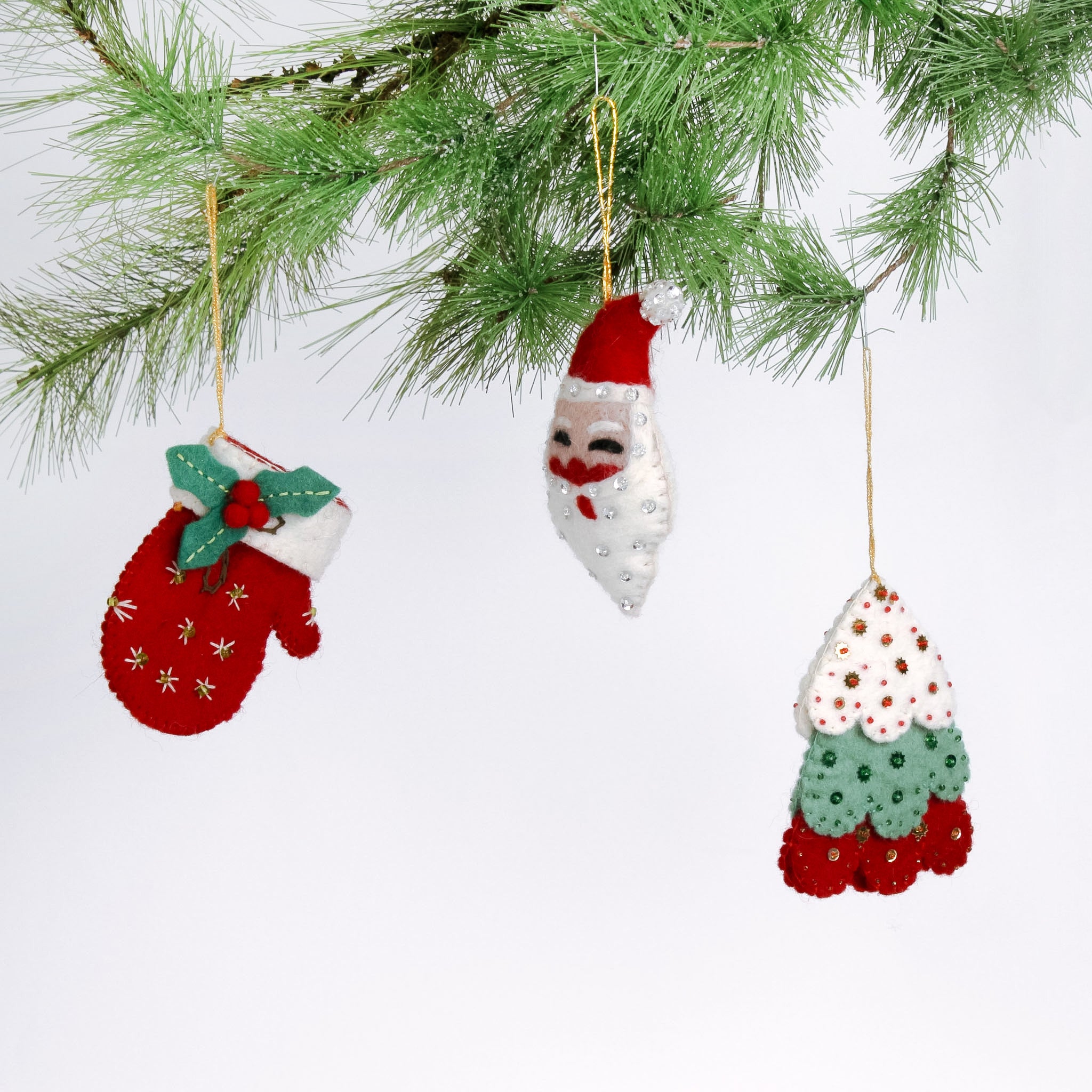 Handcrafted Holiday Icons Felt Christmas Ornaments featuring Santa, mitten, and Christmas tree designs in festive red, green, and white colors.