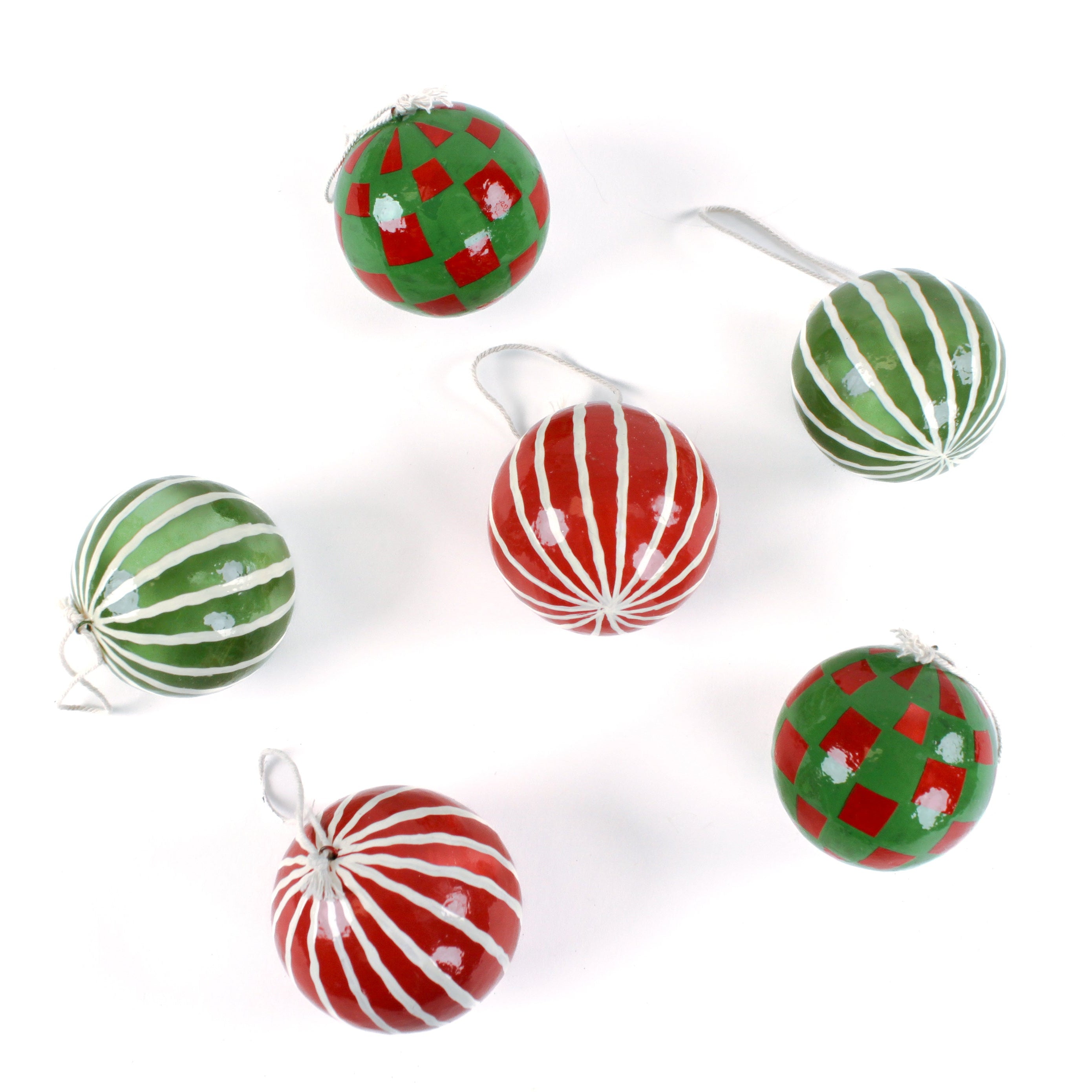 Set of red and green checked and striped hristmas ornaments on a white background