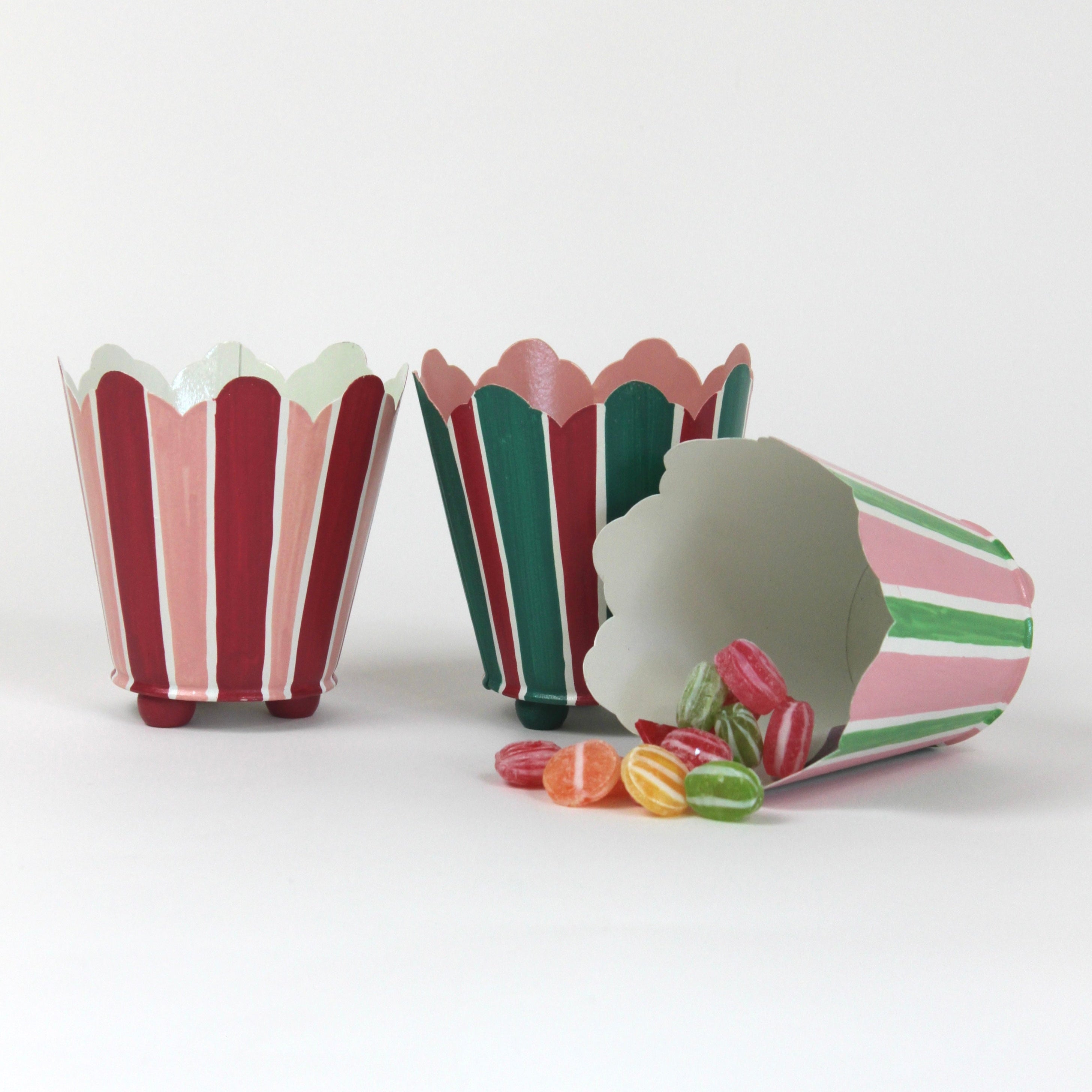 three striped cachepots in shades of pink, red and green from madcap cottage