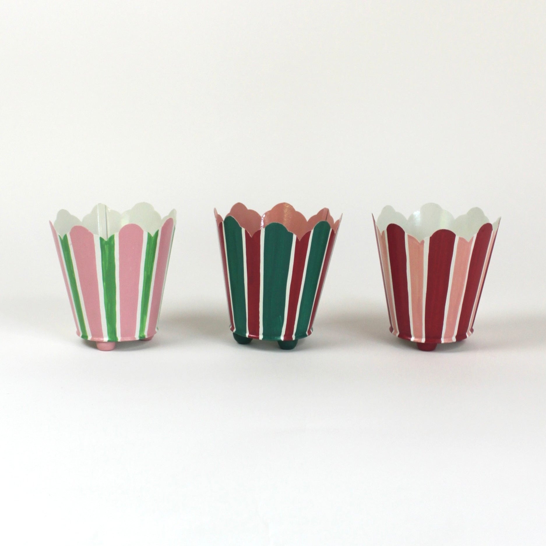 three striped cachepots in shades of pink, red and green from madcap cottage