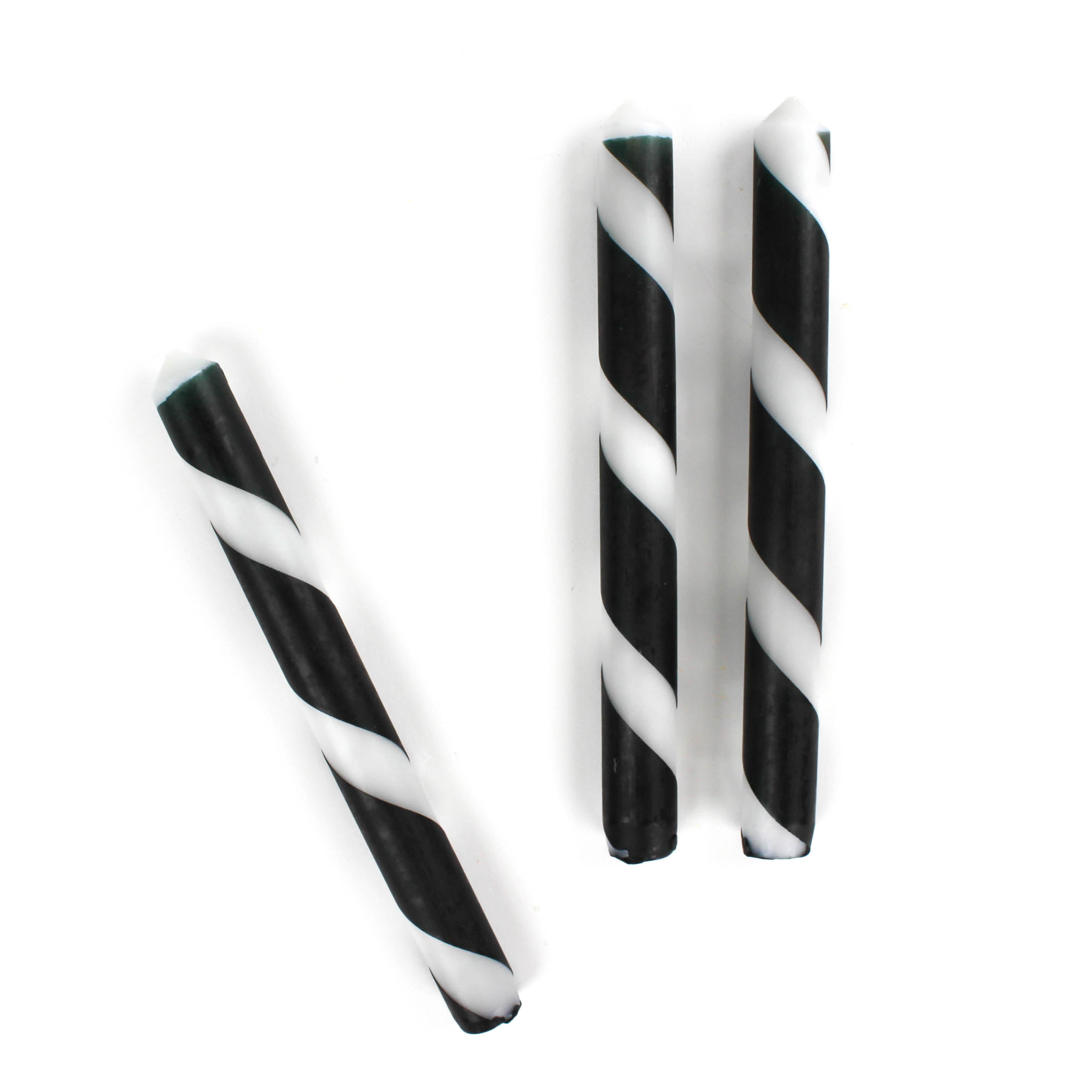 Three black-and-white taper candles on a white background
