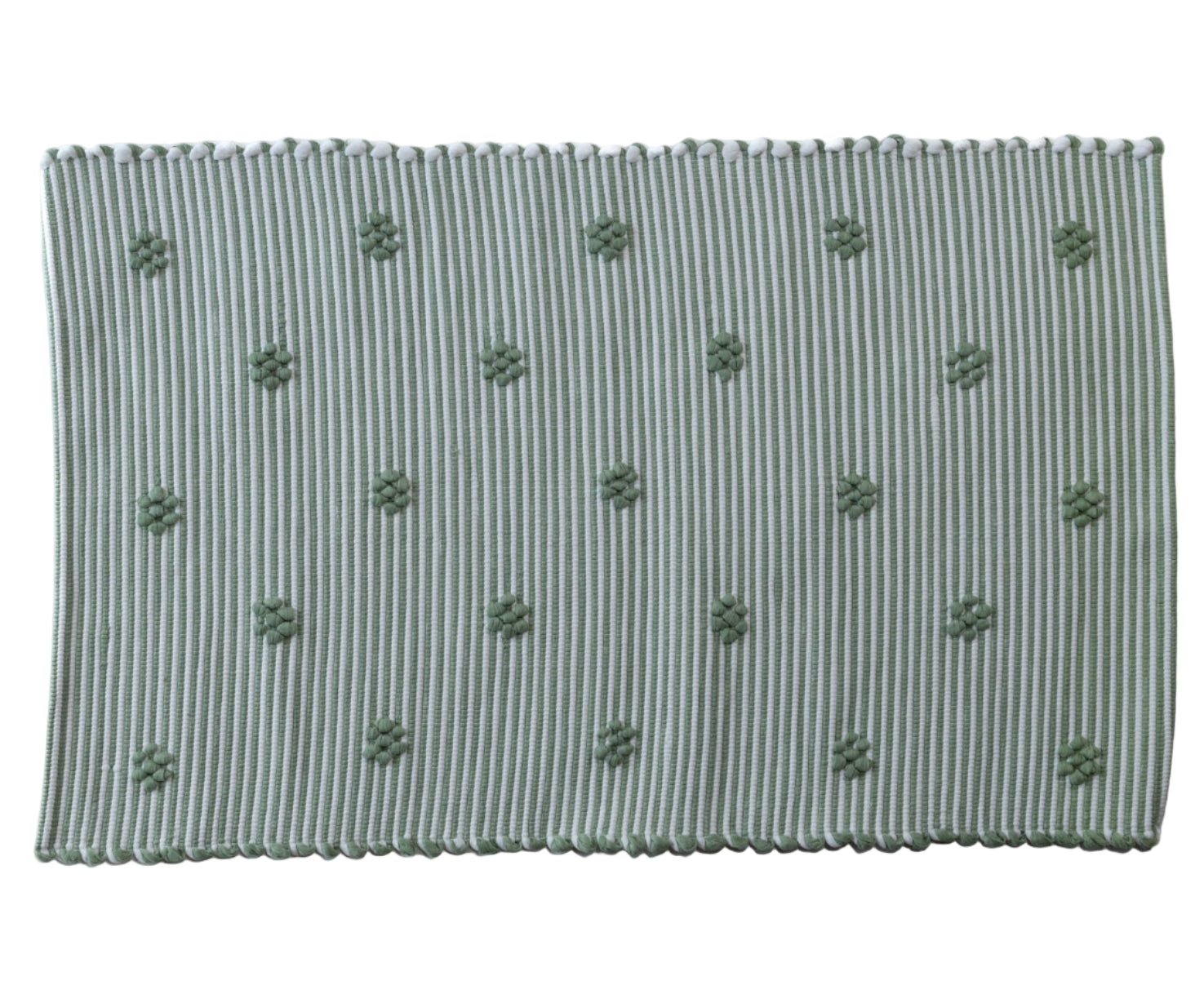 A rectangular green accent rug with small daisy shaped accents scattered across it.