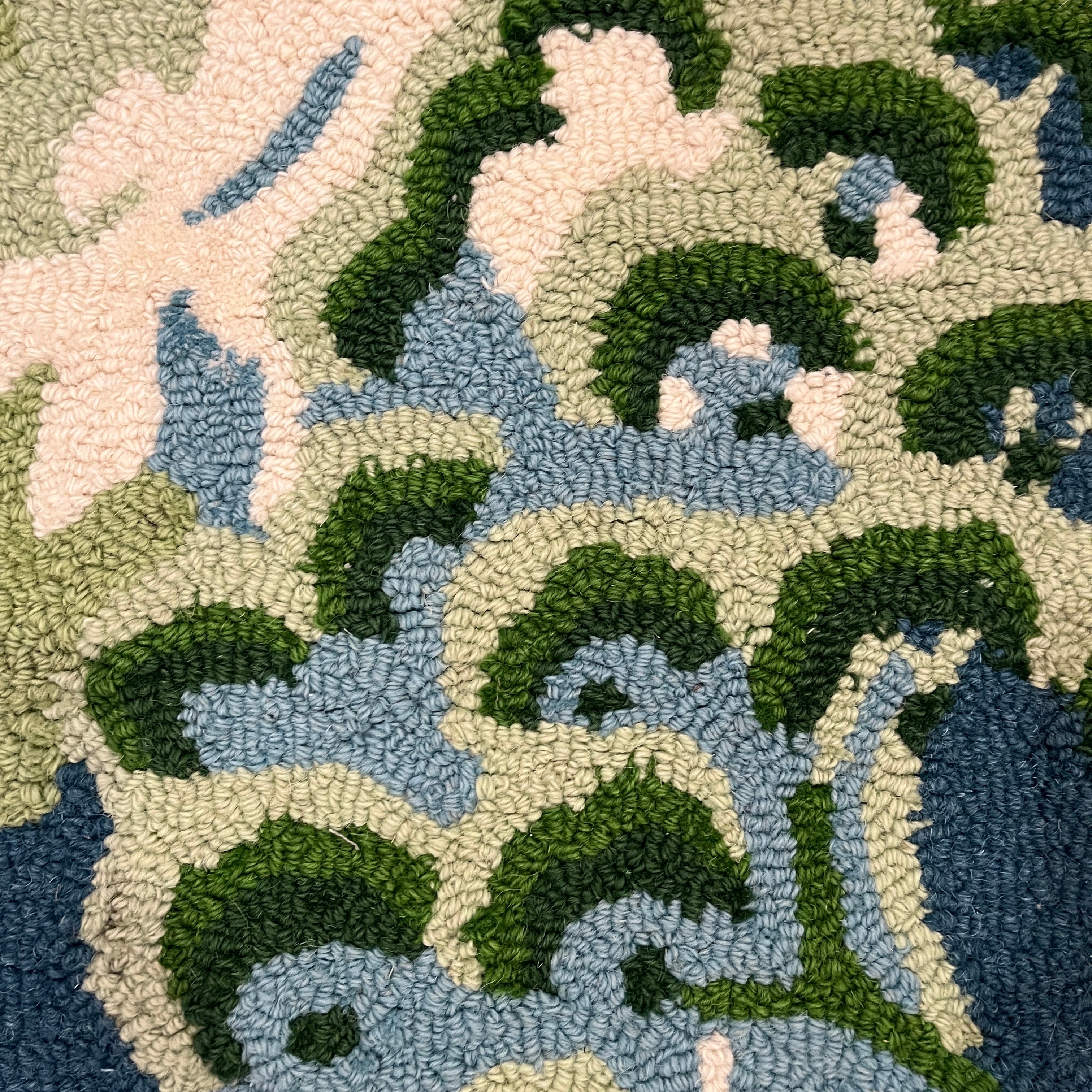 a close up of a blue and green rug with chinoiserie boatmen and pagoda motifs from madcap cottage.