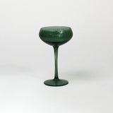 a green coupe glass on a white background from madcap cottage