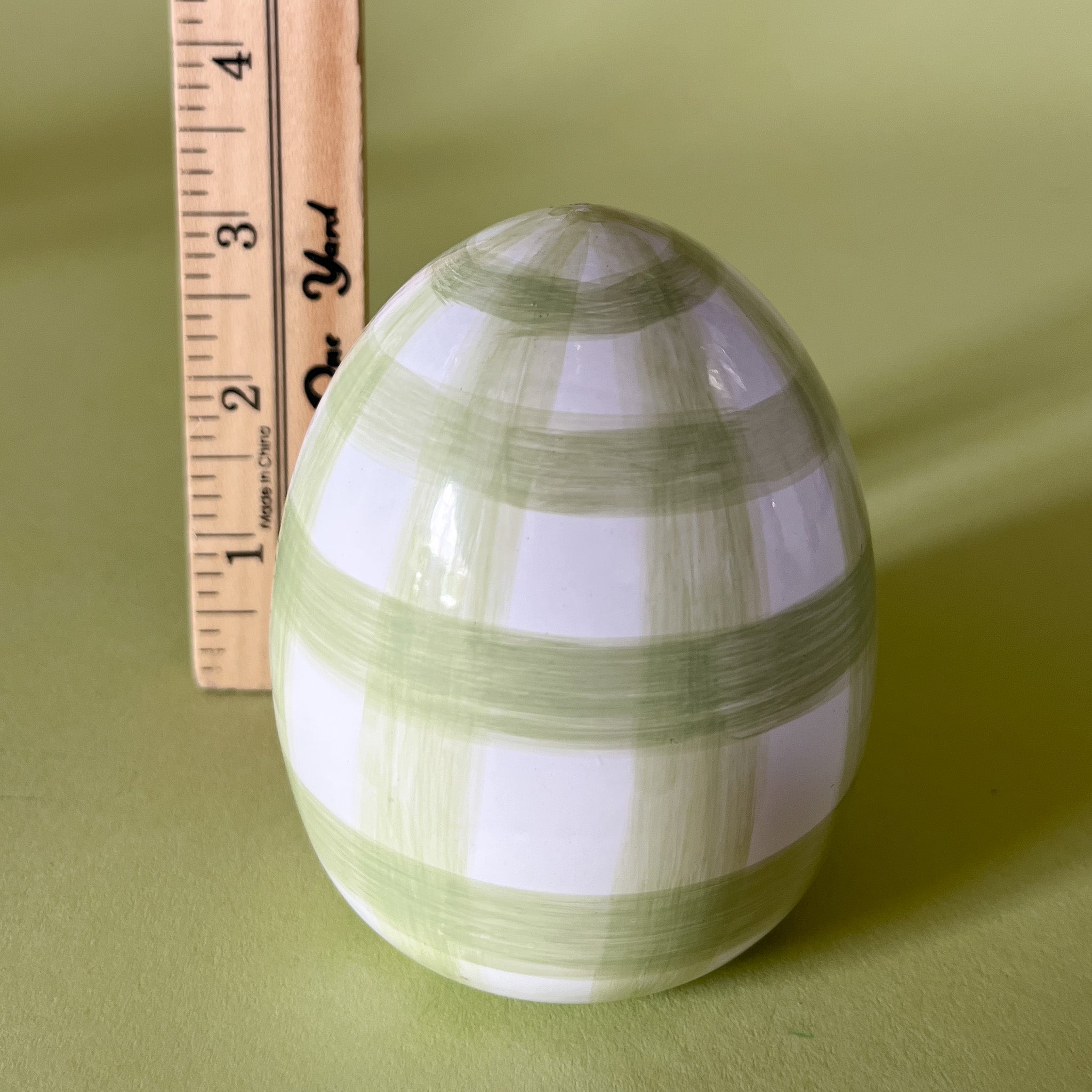 green gingham decorative easter egg with ruler to illustrate scale