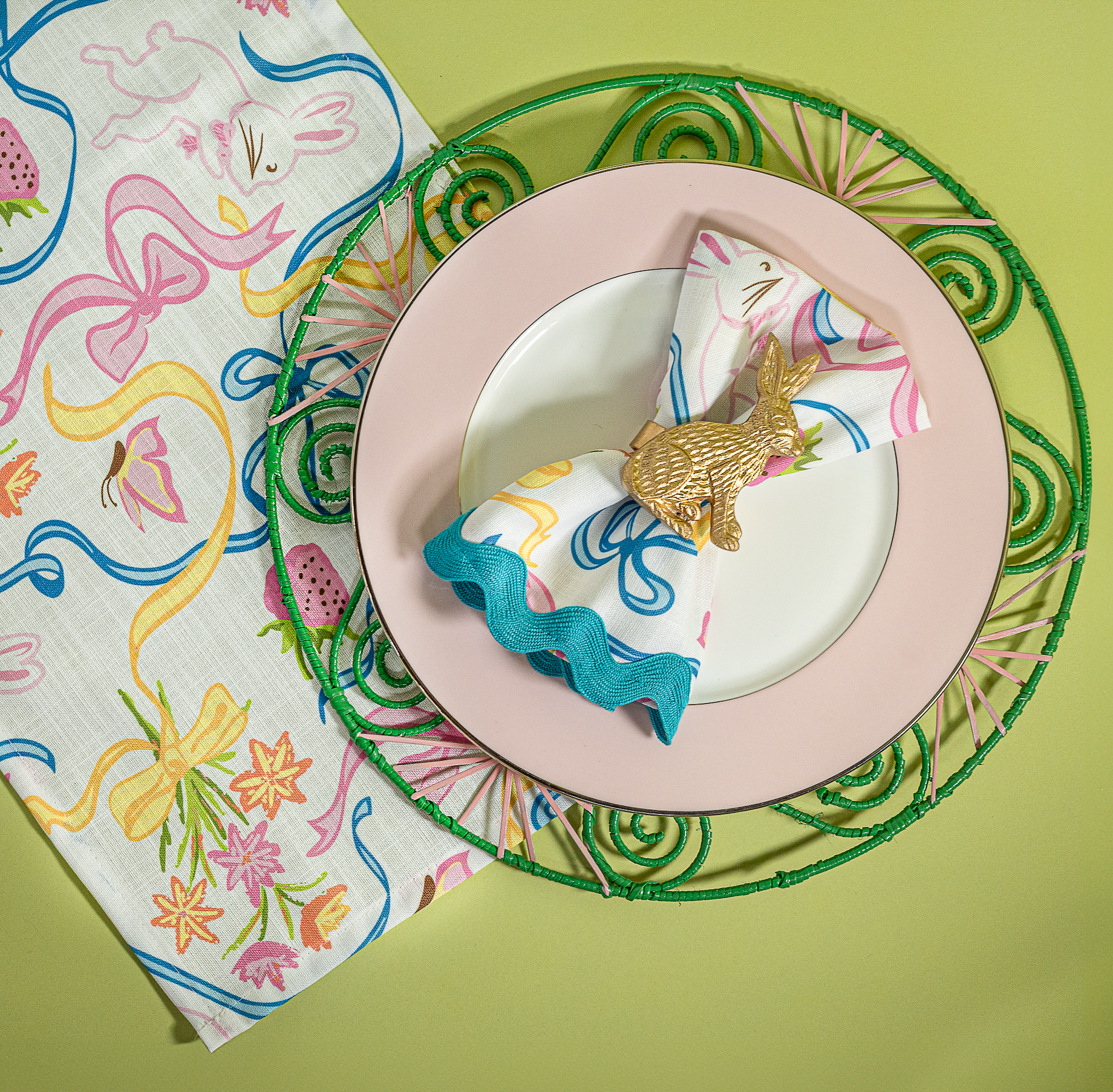 Lifestyle image of a multicolored Bunnies & Bow print cloth table runner and napkin in a bunny and bow print fabric.