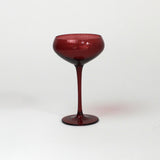 a red coupe glass from madcap cottage o a white background