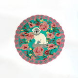 A pink and green floral rug featuring a scalloped border and large central pug motif