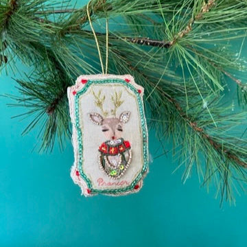 Hand Painted Beaded Reindeer Christmas Ornament with red flower and sequin details.