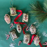 An embroidered christmas ornament set featuring all of santa's reindeer.