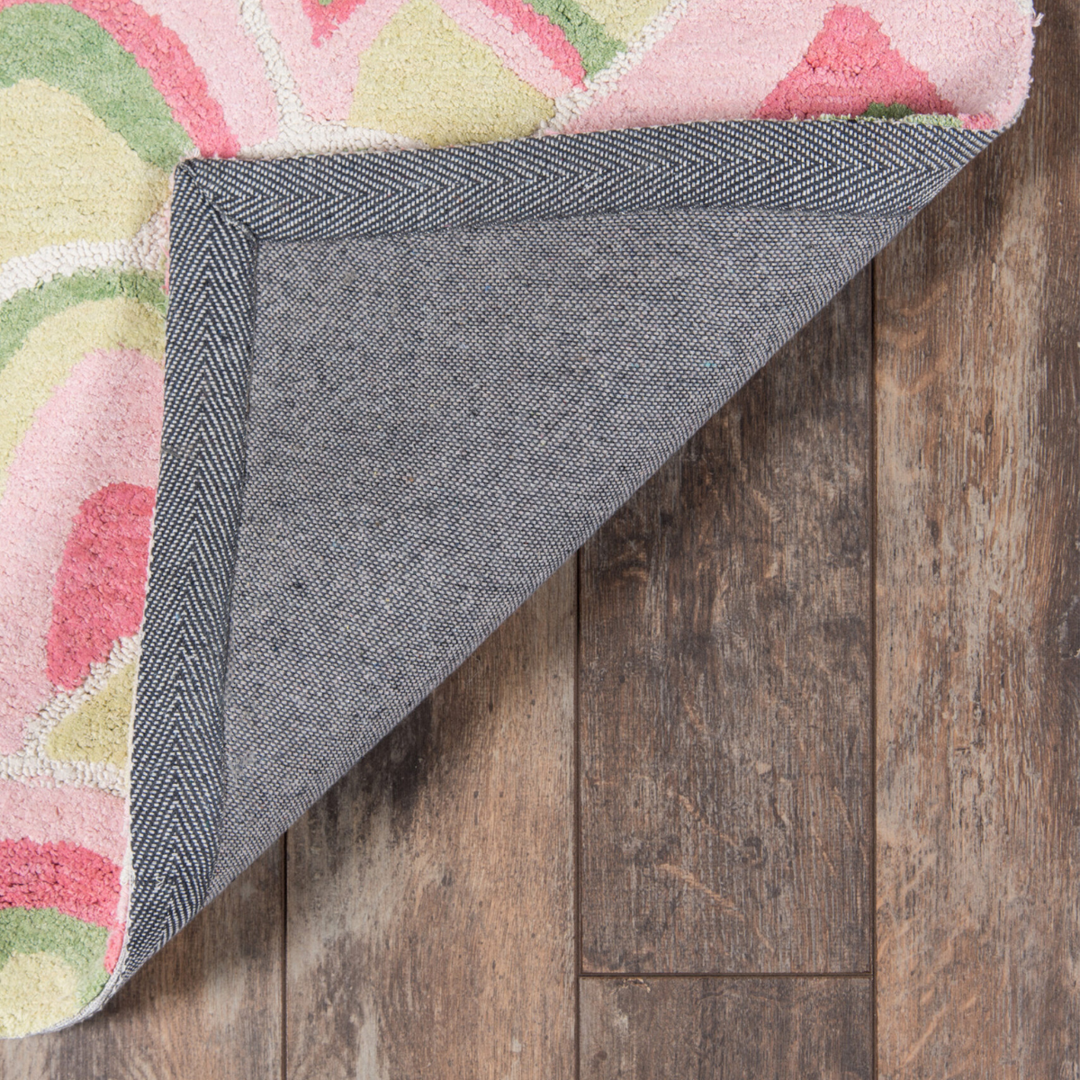 reverse side of a pink and green rug