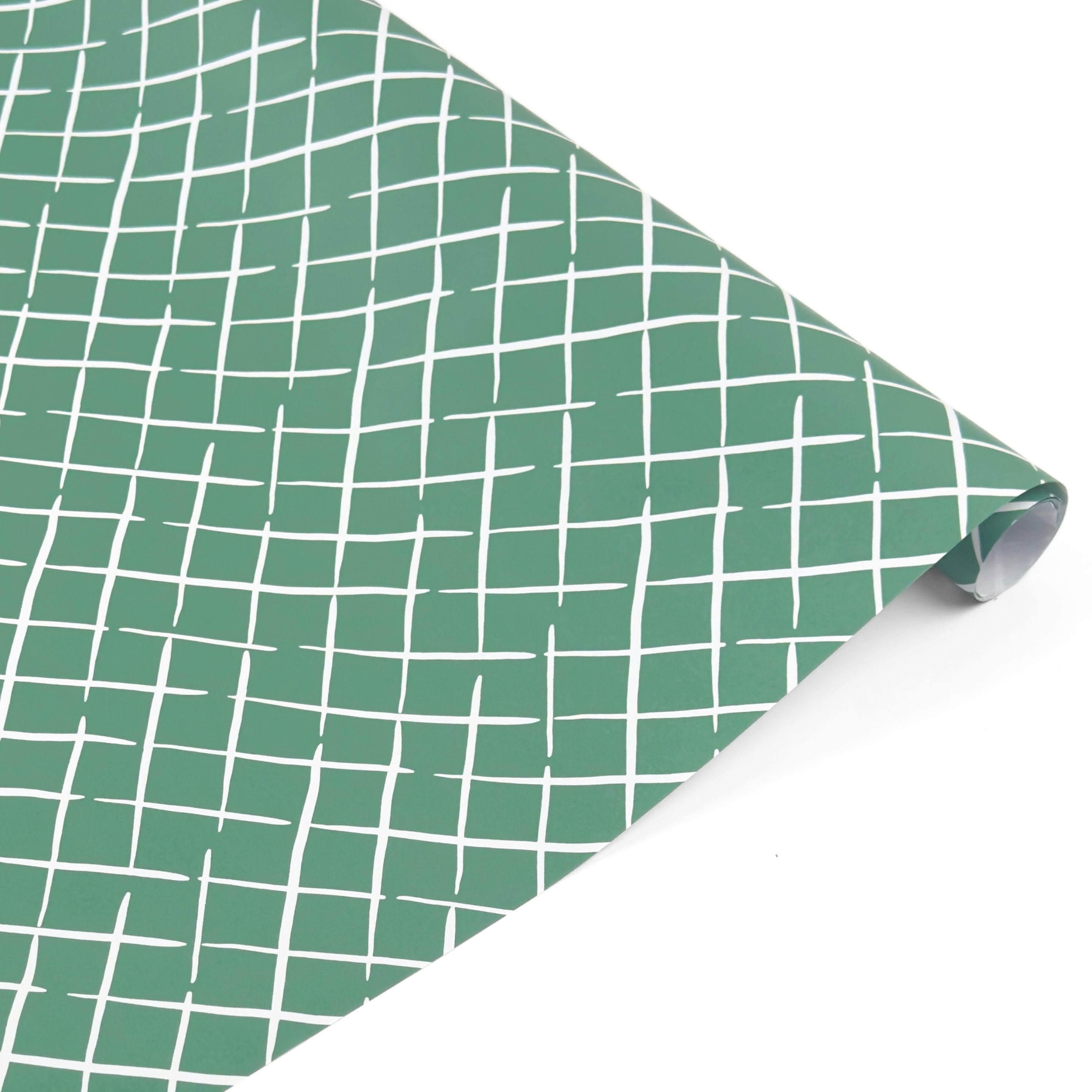 Rolled Bahama Court gift wrap featuring a charming white lattice pattern on a beautiful green background.