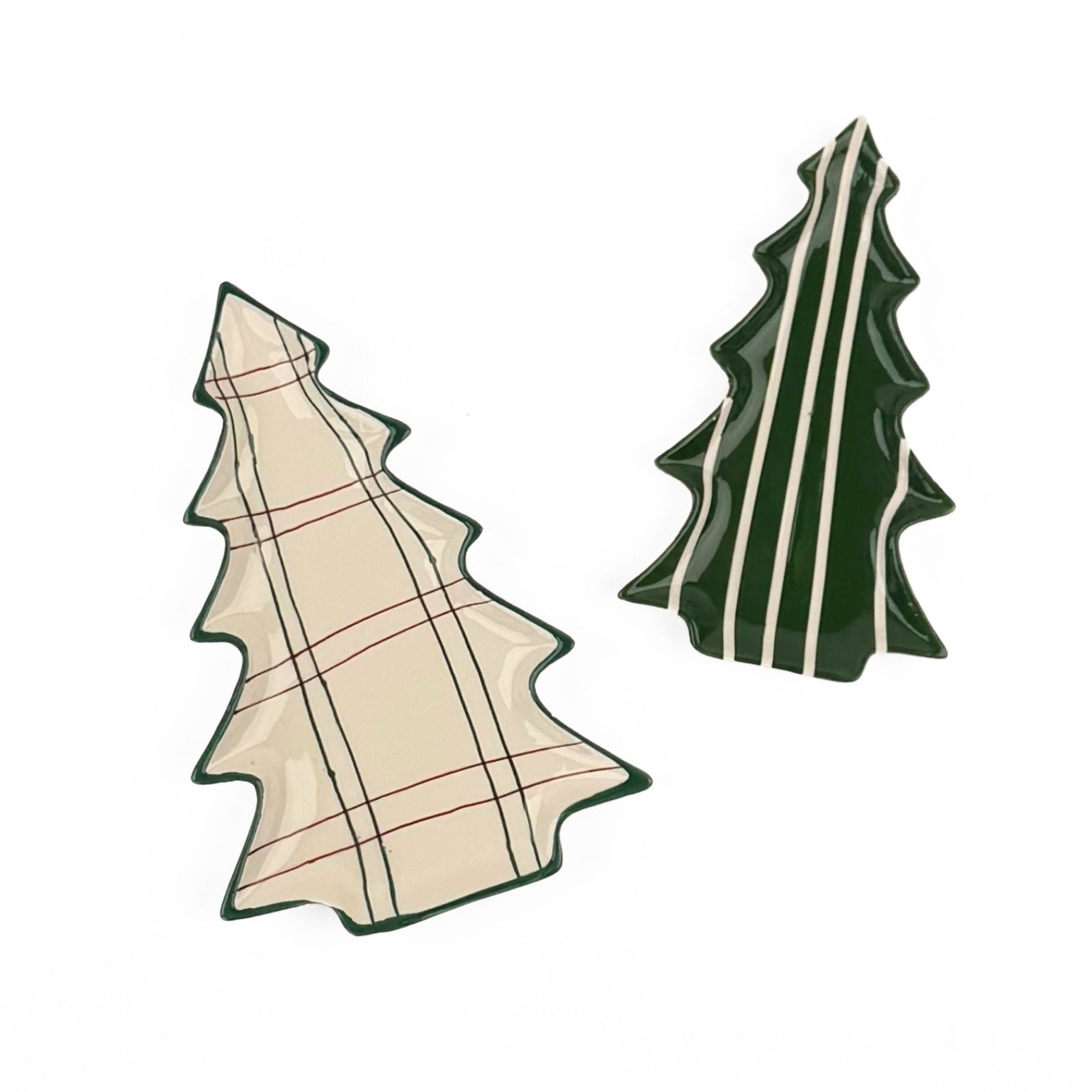 Two Christmas tree-shaped ceramic coasters on a white background, one with a beige and green plaid pattern and one with dark green and cream vertical stripes.