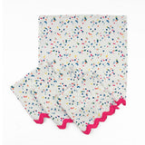 Set of White cloth dinner napkins featuring playful multicolor confetti dots and bright pink ric rac trim.