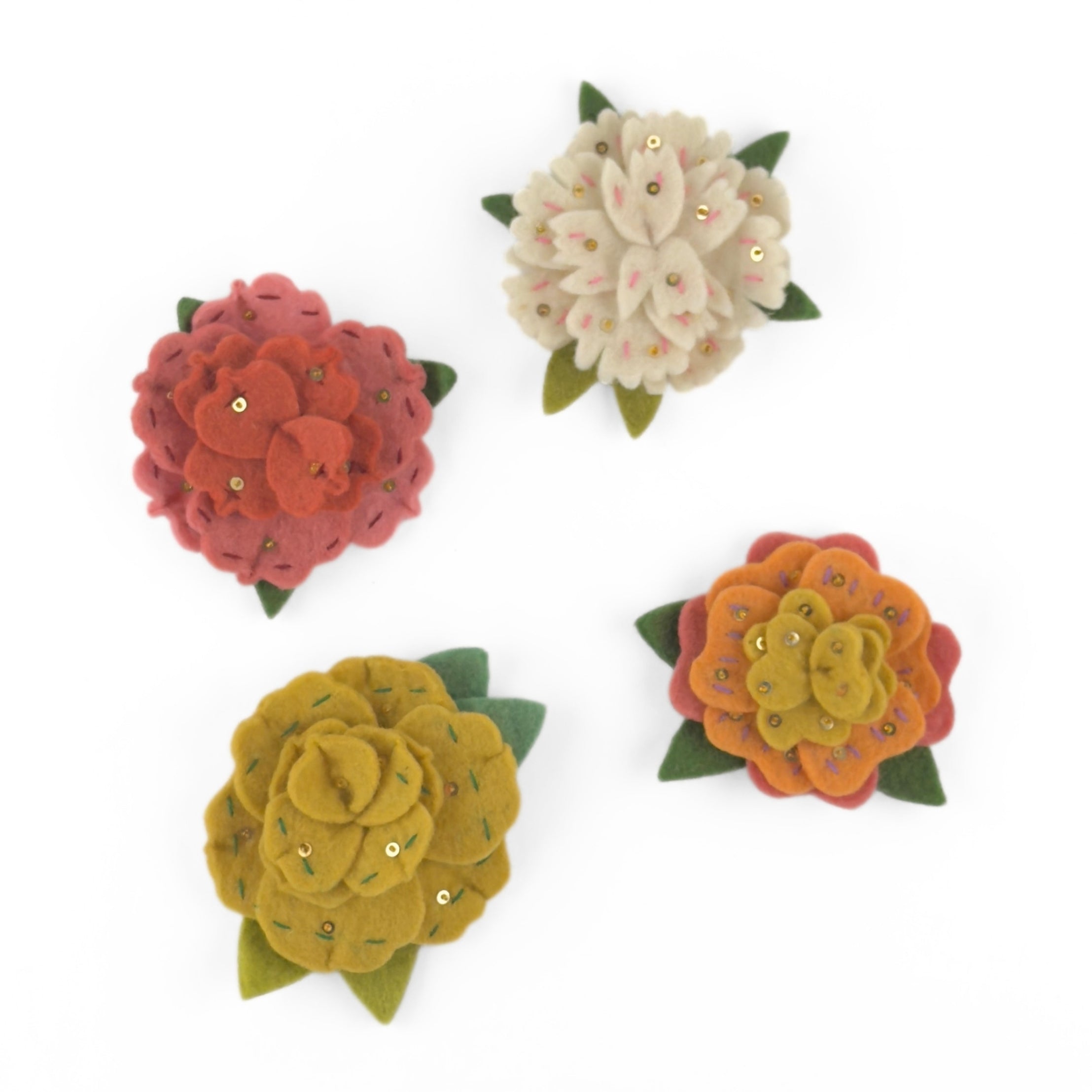 Four Charming felt flower ornaments featuring colorful layered petals, green leaves, delicate embroidery, and sparkling sequin accents.