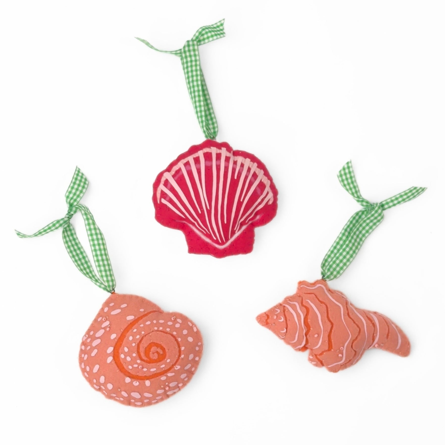 Handcrafted Pink Orange Shells Felt Christmas Ornaments featuring coral spiral, conch, and red scallop shell designs with green gingham ribbons.