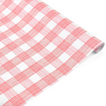 Roll of pink and white gingham patterned holiday wrapping paper.