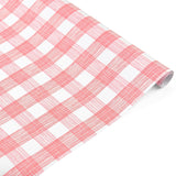 Roll of pink and white gingham patterned holiday wrapping paper.