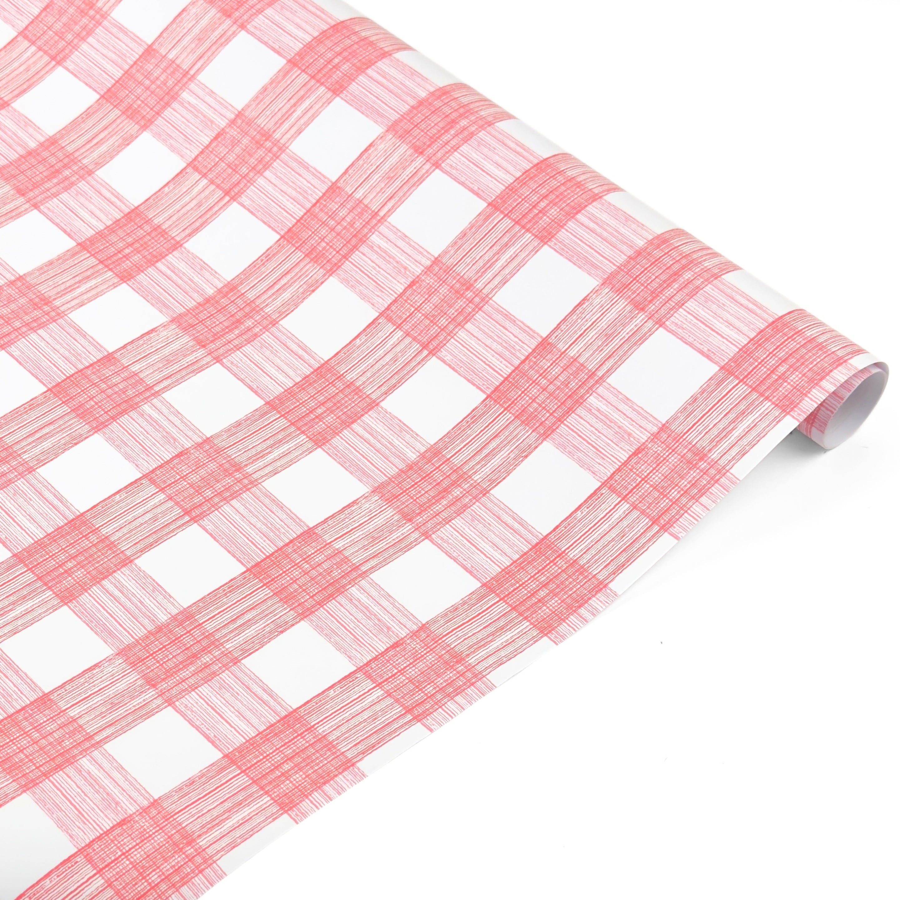 Roll of pink and white gingham patterned holiday wrapping paper.