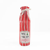 red and white striped wine bag with a “Santa, I have been goodish” label on the front