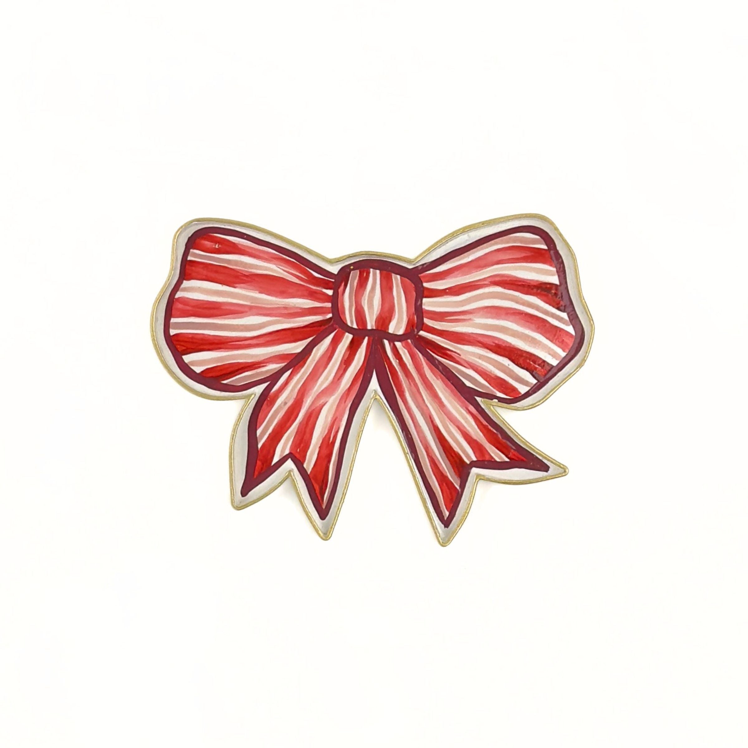 Front view of a red and white striped bow-shaped decorative tray with gold outline.