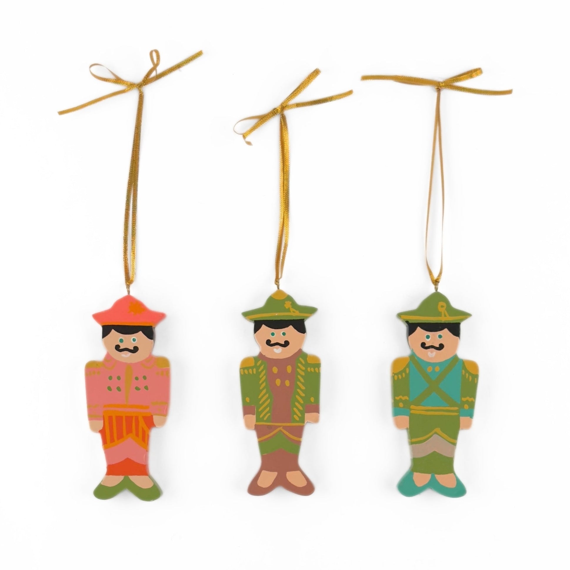 Festive hand-painted wooden nutcracker Christmas ornaments featuring colorful soldier designs and gold hanging cords for decorating.