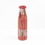 pink and green striped wine bag with “Let’s get jolly!” printed on the front