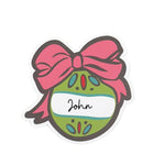 Festive ornament place card featuring a green Christmas bauble, pink bow, and personalized name space.