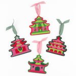 four pink felt chinoiserie christmas ornaments in the shape of pagodas against a white background 