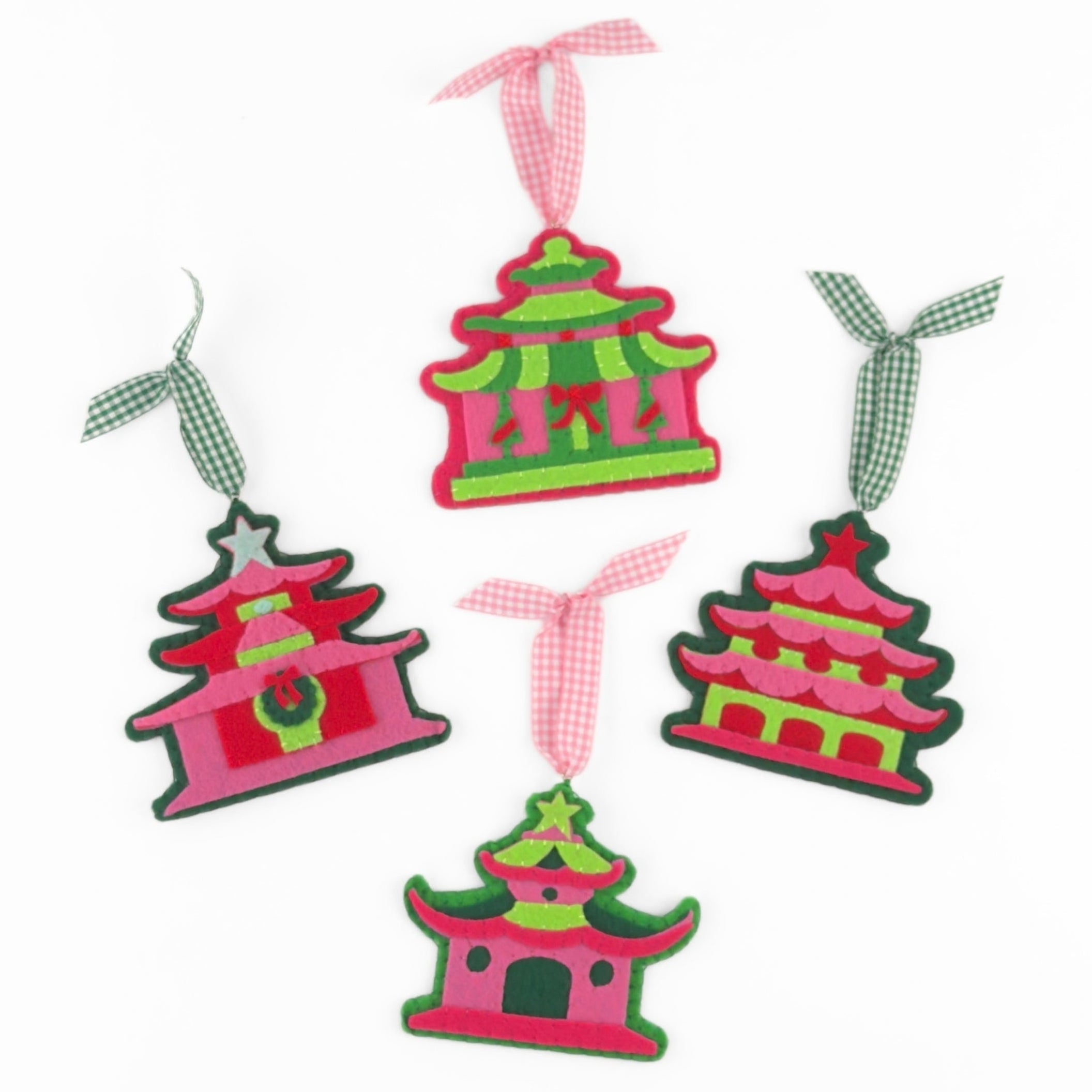four pink felt chinoiserie christmas ornaments in the shape of pagodas against a white background 