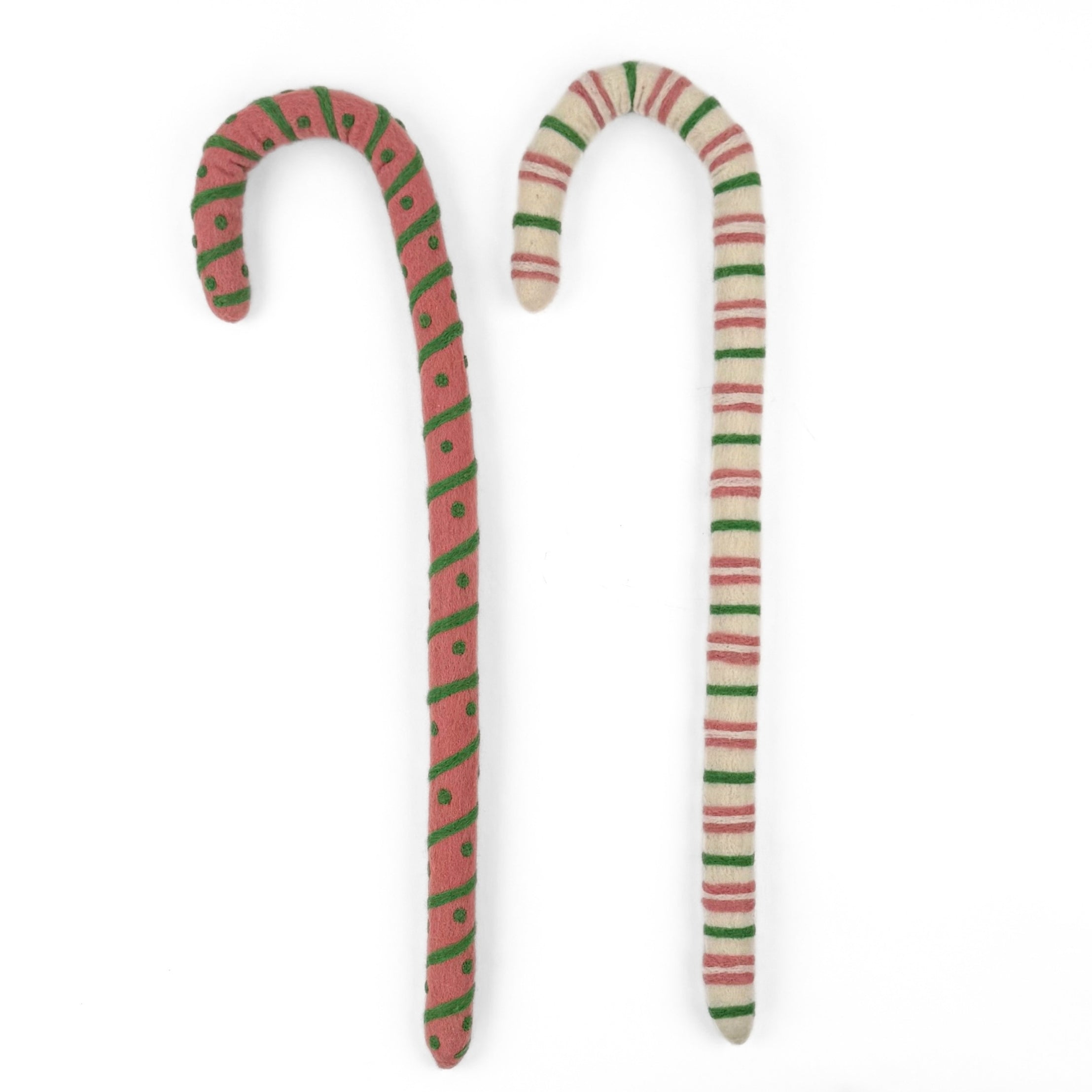 Large felt Christmas candy canes featuring festive pink, green, and cream stripes with playful patterns.