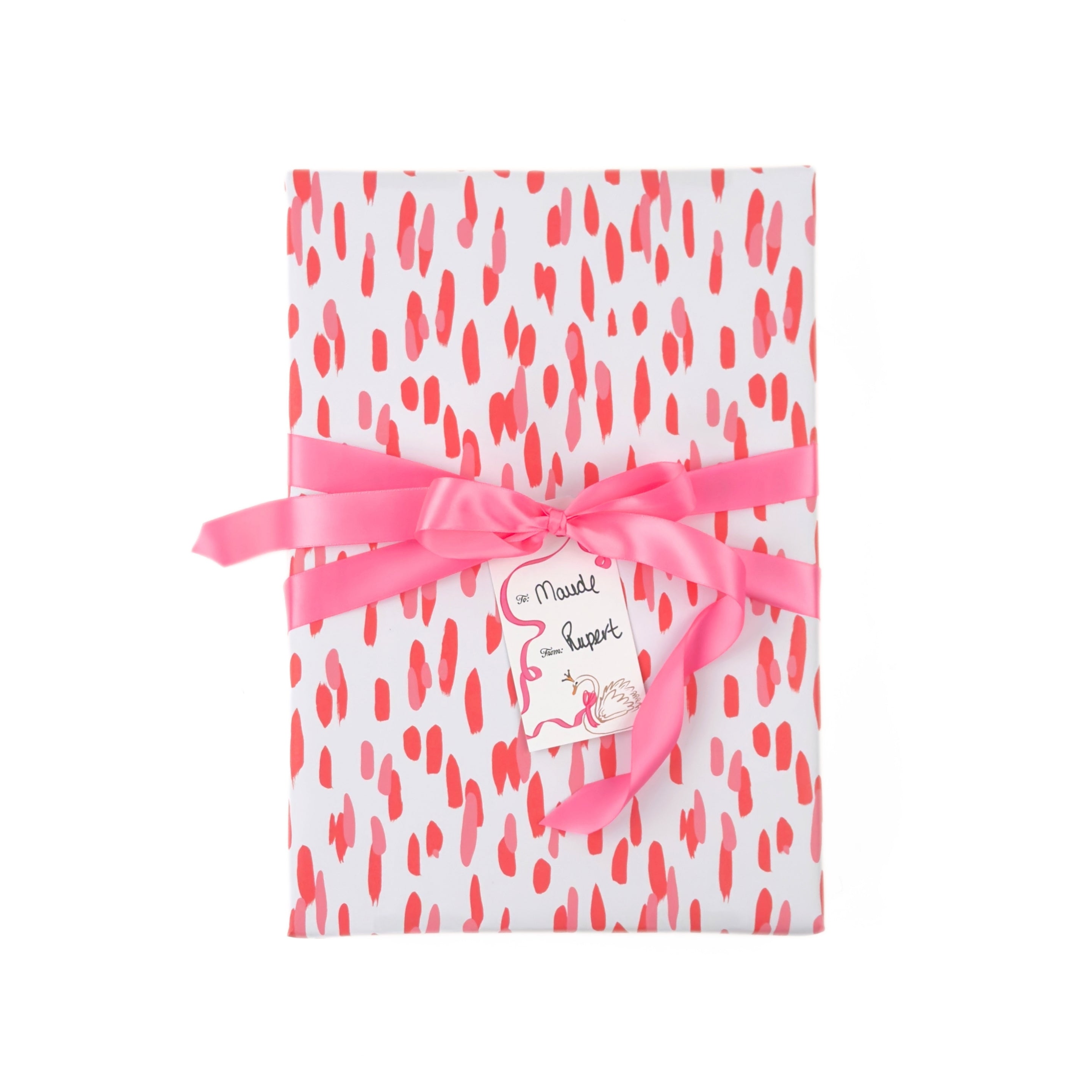 a gift wrapped in gift wrap with a pink brushstroke pattern design, tied with a pink bow. 