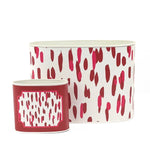 Decorative caddy set featuring bold red and pink brushstroke patterns with contrasting white backgrounds throughout.