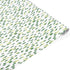 A roll of wrapping paper with a white background and a pattern of small, irregular green and light yellow brushstrokes, shown partially unrolled on a white background.