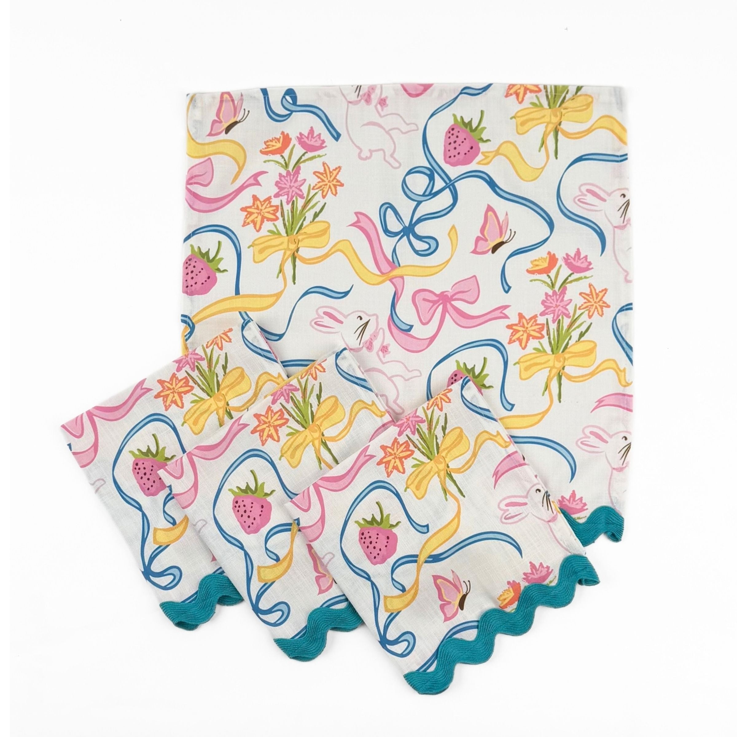 Set of White dinner napkins featuring playful bunnies, colorful bows, strawberries, flowers, and turquoise ric rac trim.