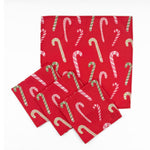 Set of Red cloth dinner napkins featuring playful pink, white, and green candy cane patterns for Christmas tablescapes.