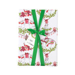 A wrapped gift box featuring holiday wrapping paper with a festive Christmas mouse pattern, tied with a bright green ribbon and bow. The paper is decorated with illustrations of white mice wearing red scarves and holding red gift boxes, surrounded by green holly and wreath motifs.