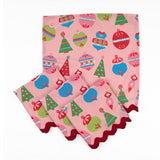 Set of Pink Christmas dinner napkins featuring colorful ornaments, festive trees, and red scalloped trim for tablescapes.
