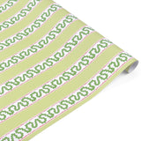 Light green Christmas wrapping paper roll with red and green holly-inspired stripe pattern, partially unrolled on a white surface.