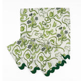 Set of White dinner napkins featuring green bunnies, bows, strawberries, floral patterns, and dark green ric rac trim.